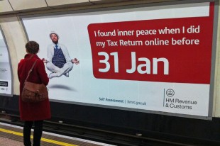 woman looking at tube station billboard showing a levitating man who has found inner peace by completing his tax return before the deadline