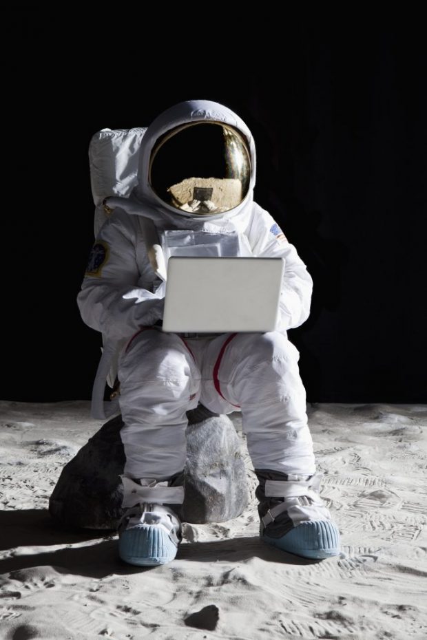 Astronaut looking at laptop