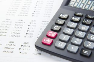 calculator on top of a finance spreadsheet
