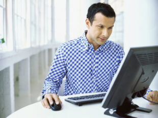 man sitting in front of a computer