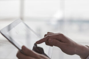 Close-up of hands using a digital tablet