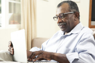 Man using laptop at home