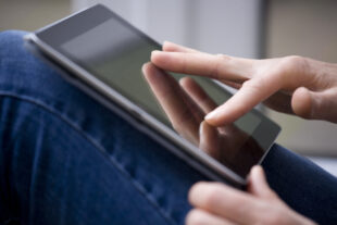 close-up of hands using a digital tablet