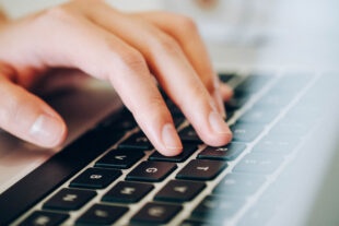 Close-up of fingers on a computer keyboard