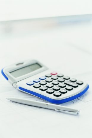 Calculator and pen on top of a document