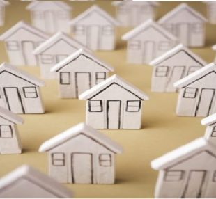 Rows of models of white wooden houses