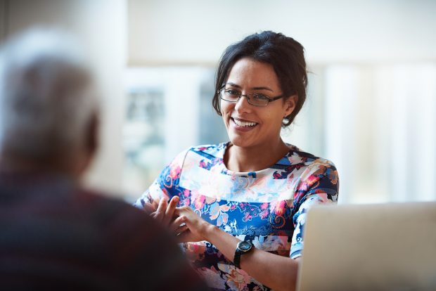 Smiling business woman discussing a project with a male colleague